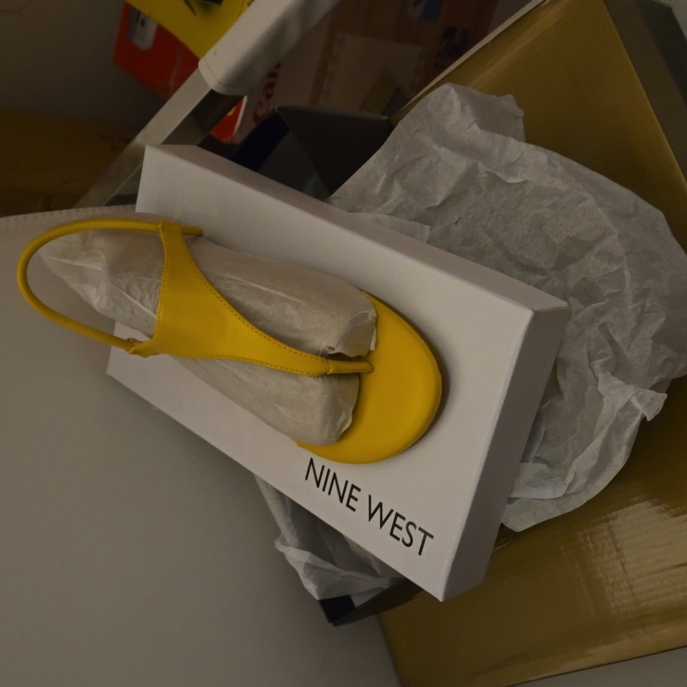 A pair of yellow Nine West sandals